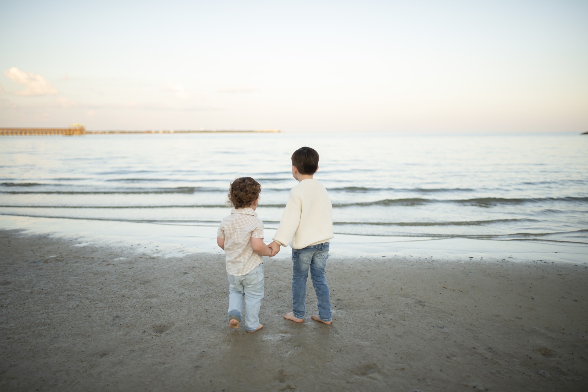 Two boys walking together along the Bay St. Louis shoreline