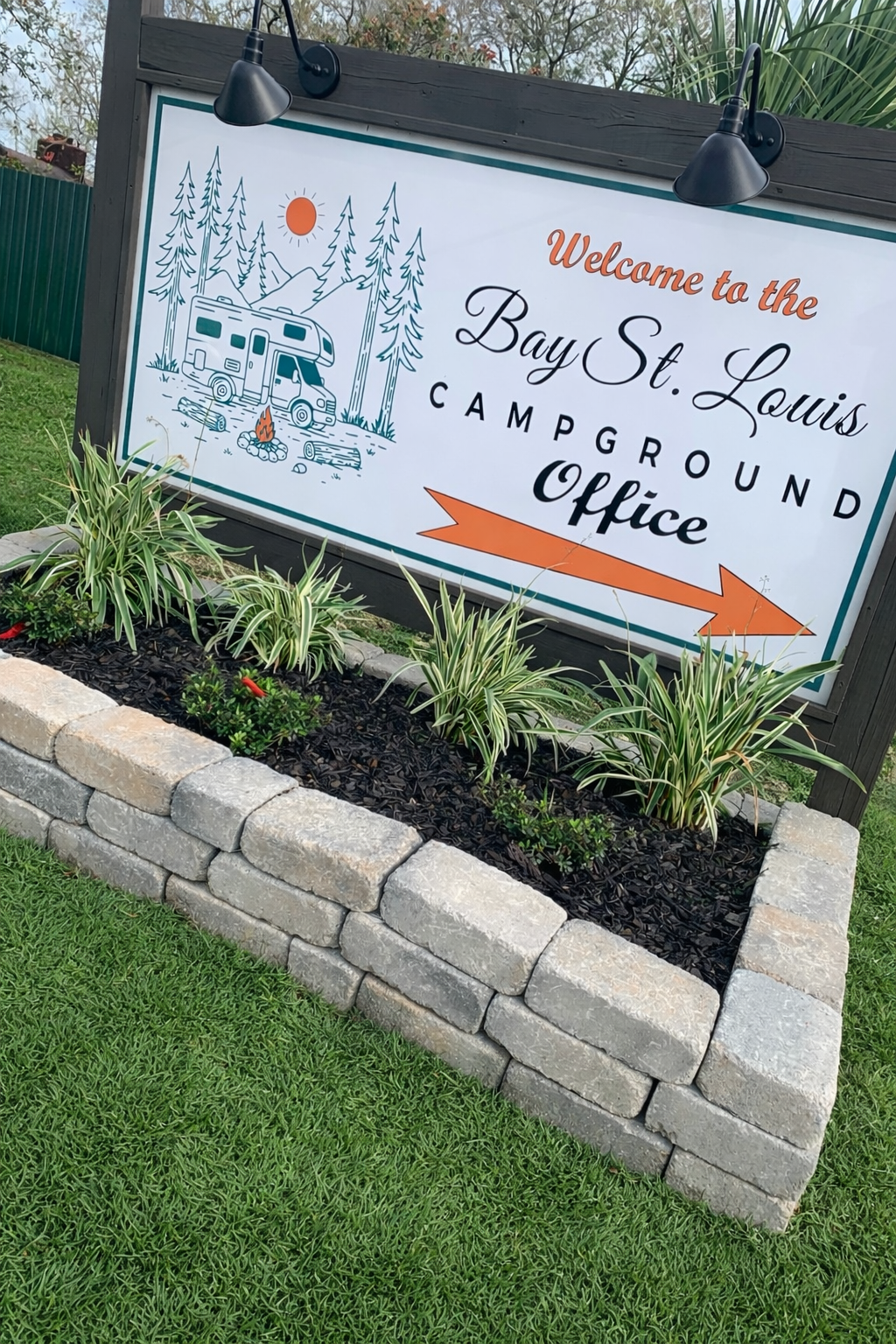 Bay St. Louis Campground directional sign near Avocado's that guides guests to the park entrance